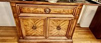 Front view of the silent butler dresser showing the upper drawer with wooden knob and double-door compartment with metal ring pulls. Visible extended flat surfaces on the sides.