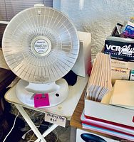 Close-up of Presto Heat Dish personal heater on folding tray table