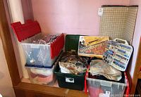 Bins stacked with various fabric pieces, rotary tool accessory set, woodburning kit, and cutting mats visible in the background.