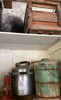 Overview photo showing vintage steel pressure cooker, wooden ice cream maker, and wooden crates above.