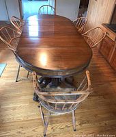 Overview of oval table with seven Windsor chairs surrounding