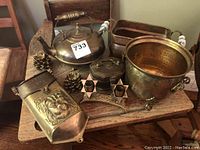 Full lot on wooden table showing brass letter box, tea pot, planter bowl, rectangular planter, octagonal box, pine cone decorations, star tealight holder