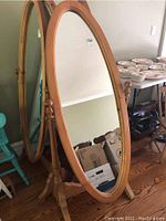 Full view of the oval pine cheval mirror showing the entire mirror, frame, and stand.