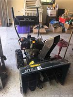 Front view showing auger housing and discharge chute.