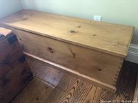 Front view of the pine trunk showing rectangular shape, natural pine wood, and surface marks.