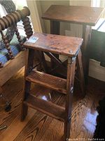 Two vintage wooden step stools photographed together showing their size and condition including marks and scratches.