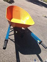 Angled front view showing orange tray and blue handles