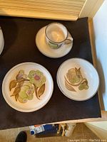 Single tea cup with matching saucer, dessert bowl and dessert plate showing floral pattern.