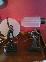 Overview of both lamps side by side on wood table, showing base and shades