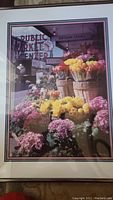Framed photographic print featuring colorful flowers and Public Market Center sign at Pike Place Market.