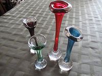 Front angled view of all four glass vases showing color variety and bubble bases