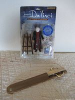 Full view of the Leonardo Da Vinci Figure set in original packaging showing the figure, easel, and framed paintings.