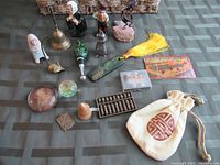 Overview of miscellaneous small items and basket on a green patterned fabric surface