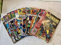16 vintage Marvel comics spread in fan arrangement showing colorful front covers including special issues and character-specific editions