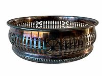Close-up side view of the silver plated wine bottle coaster showing pierced decorative pattern and beaded rim.
