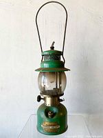 Full front view showing entire lantern, enamel body, globe and handle