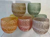 Five of eight colored crackle pattern Shat-R-Pruf tumblers arranged in a group showing colors and patterns.
