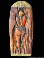 Front view on black background showing relief carving detail