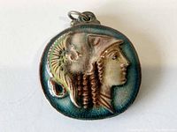 Front view of circular ceramic pendant with raised Roman soldier figure and glaze crackle