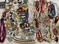 Full overview showing large assortment of beads, bracelets, brooches, and necklaces of various colors and materials.