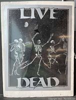 Full view of the 1984 vintage 'Live Dead' poster by Bruce Campbell showing dancing skeletons and stylized text.