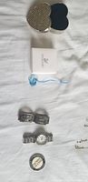 Photo shows heart-shaped jewelry box with clear crystals on lid, dark velvet interior, Swarovski blue crystal rose ornament, silver linked bracelet, Michael Kors silver tone watch with white dial, and Invictus Games round medallion.