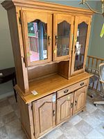 Front view of the Canadian made solid wood buffet and hutch by Candel, showing three glass doors on the hutch and three wood doors with a drawer on the buffet