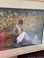 Full view of large impressionist print showing woman and child on garden bench surrounded by flowers