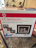 Boxed HP 8-inch digital picture frame with 2GB internal memory showing front of the retail packaging