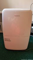 Front view of white rectangular Garrison dehumidifier with brand name visible