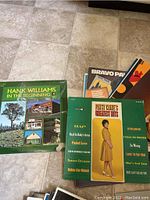Photo of various LP records including Hank Williams, Patsy Cline, and Bravo Paris.