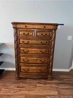 Front view of the Havertys tall wood carved dresser showing full height and drawers.