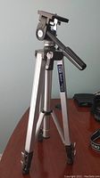 Photo of the full Kenlock tripod showing aluminum legs, pan-tilt head with handle, and leg locks.
