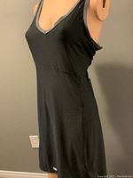 Black sleeveless Louis Garneau biking dress on a mannequin showing front body fit and grey trim around neckline and armholes.