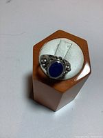 Top view of the sterling silver ring showing the oval lapis lazuli stone centered on a decorative band with bead accents.