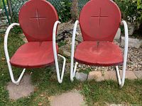 Front view of both chairs showing red circular seats and backs on white frames