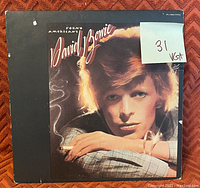 Front cover of David Bowie Young Americans album showing vinyl record sleeve with artist photo and grading note.