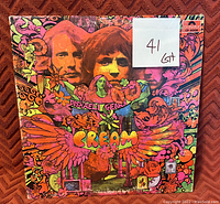 Front cover of Cream's Disraeli Gears album with vibrant psychedelic artwork and band member portraits.