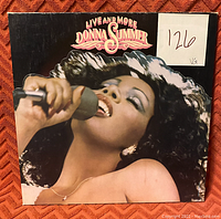 Front cover of Donna Summer's Live and More album showing her singing into a microphone with condition label '126 VG'.