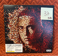 Front cover of Eminem's Relapse vinyl record showing detailed media grading (NM 37) and album art.