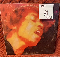 Photo of Jimi Hendrix album cover with visible wear, showing grading sticker '6+ VG' and note 'Nice!' on top right corner.