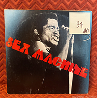 Front cover of the 'Sex Machine' album showing James Brown and album title in red letters, with VG+ grade sticker.