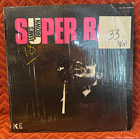 Front cover of James Brown's 'Super Bad' vinyl record with grading sticker and wear marks.
