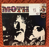 Front cover of 'The Mothers' vinyl record album, showing artistic black and white image of a man's face with colorful title lettering, and some wear marks on the sleeve.