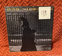 Front cover of Neil Young's 'After The Gold Rush' vinyl showing album artwork, condition sticker, and graded VG.