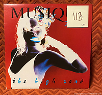 Image of the Roxy Music vinyl record sleeve showing the album cover art with a high-contrast white silhouette of a woman against a red background and colored text 'the high road'. There is a white sticky label with '113 NM' written on it.