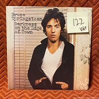 Front cover of Bruce Springsteen's Darkness on the Edge of Town vinyl record showing the album name, artist, and image of Bruce Springsteen.