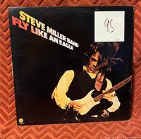 Front cover of the Steve Miller Band Fly Like an Eagle vinyl record showing album art and a grade sticker marked 95 VG.