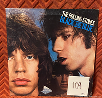 Close-up image of The Rolling Stones 'Black and Blue' vinyl record album cover featuring band members' faces and title.