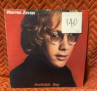 Front cover of Warren Zevon's 'Excitable Boy' vinyl record showing album art and condition note VG+.